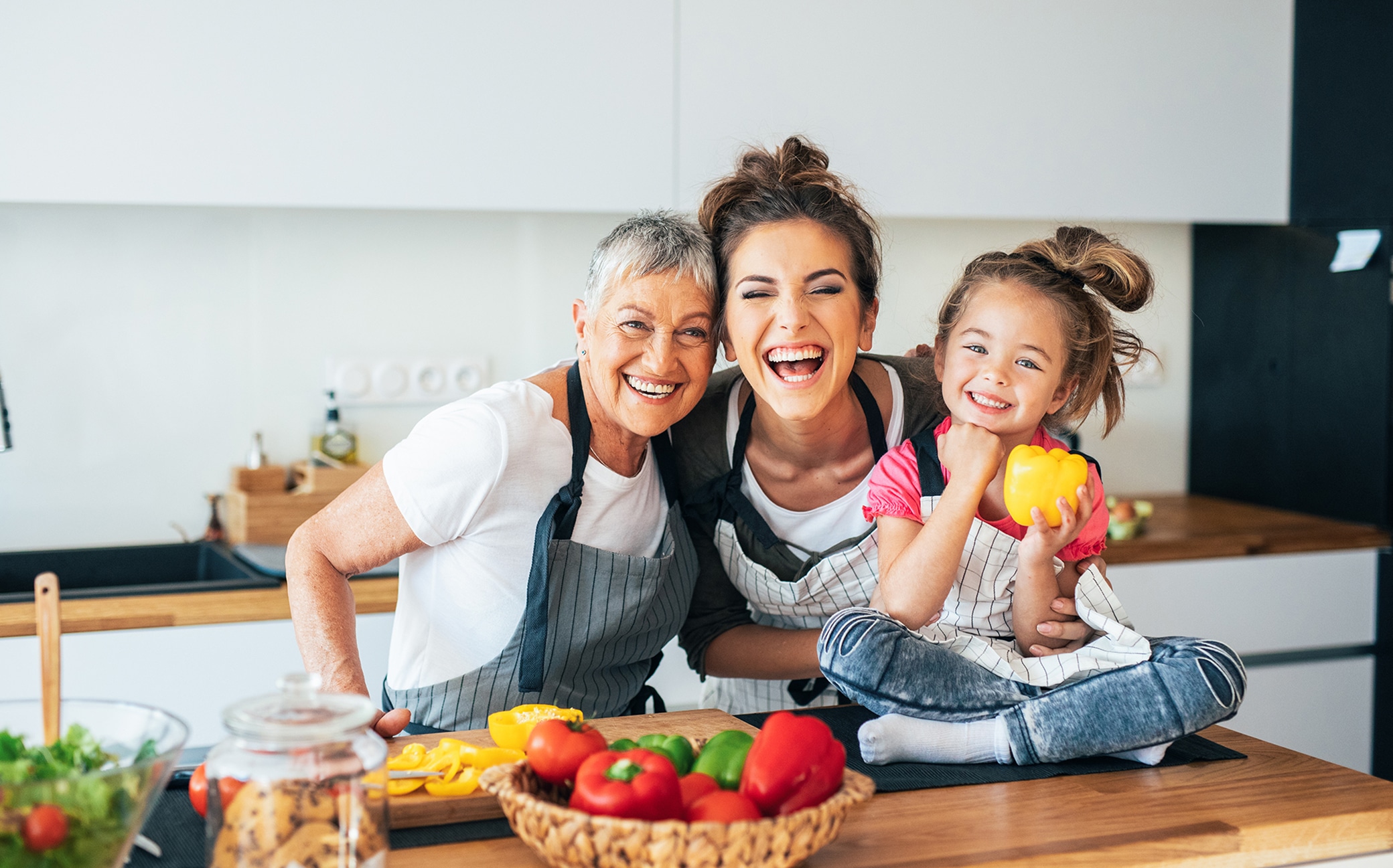 Grandmother, mother and little girl in the kitchen