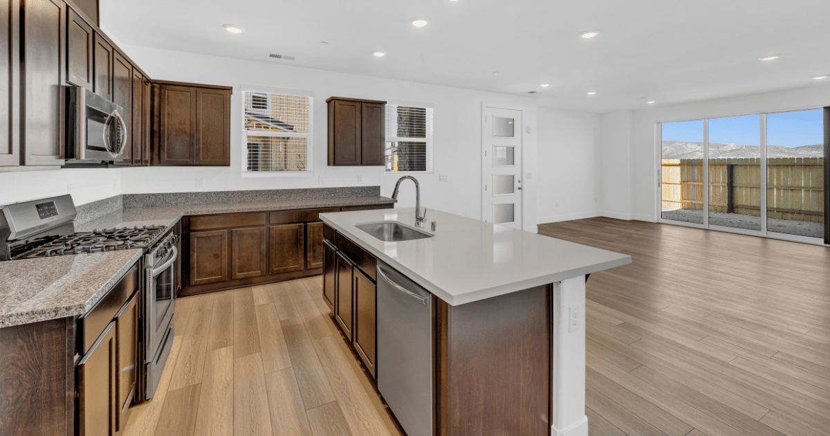 A photo of an open floor plan layout kitchen in a townhome-style condominium home at The Village South